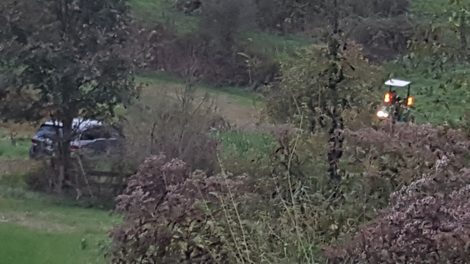 Minivan (left) about to be pulled out by tractor (right)